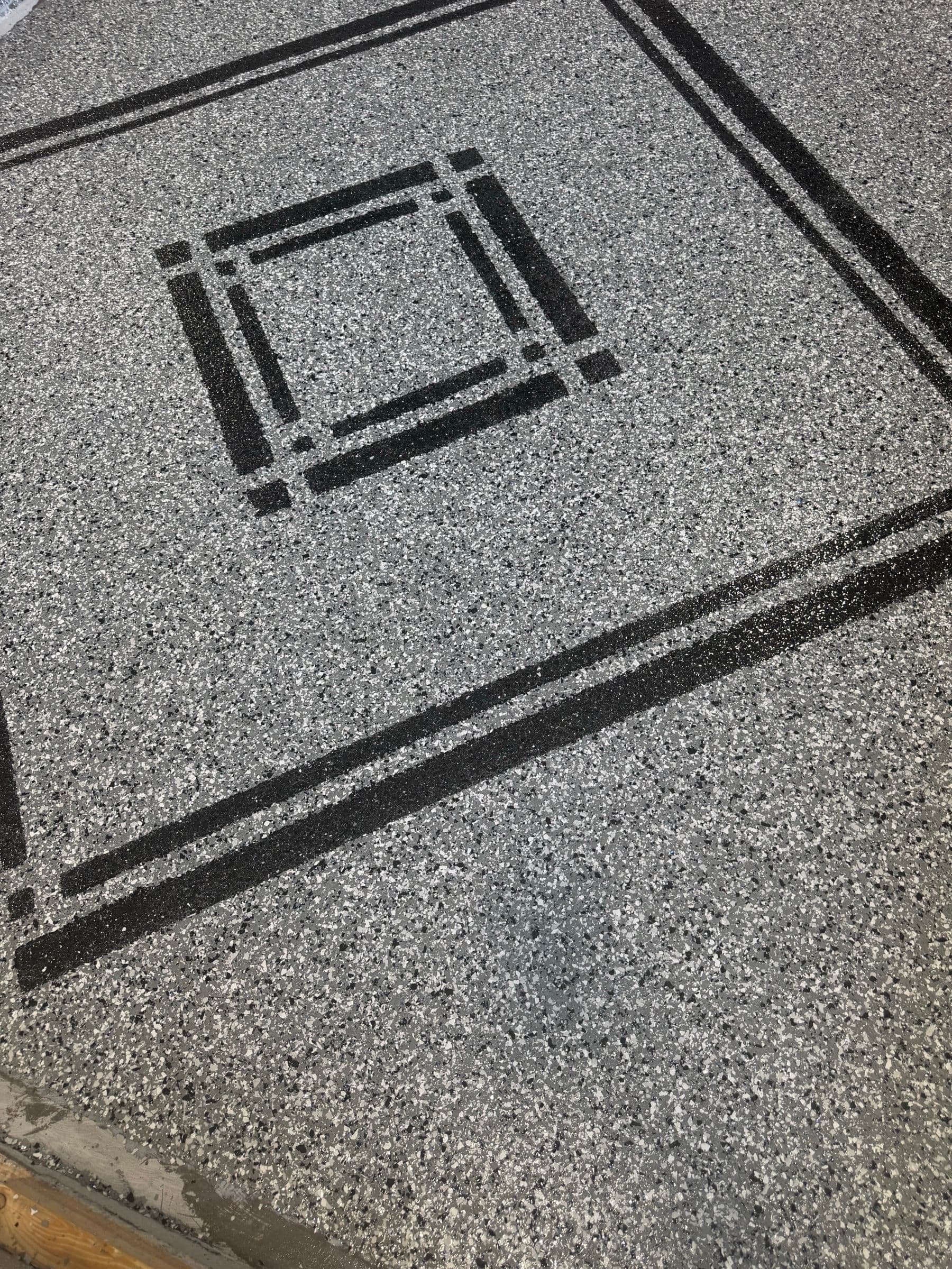 Grey flake floor with a black inlay border by Colin Coatings, Des Moines, Iowa