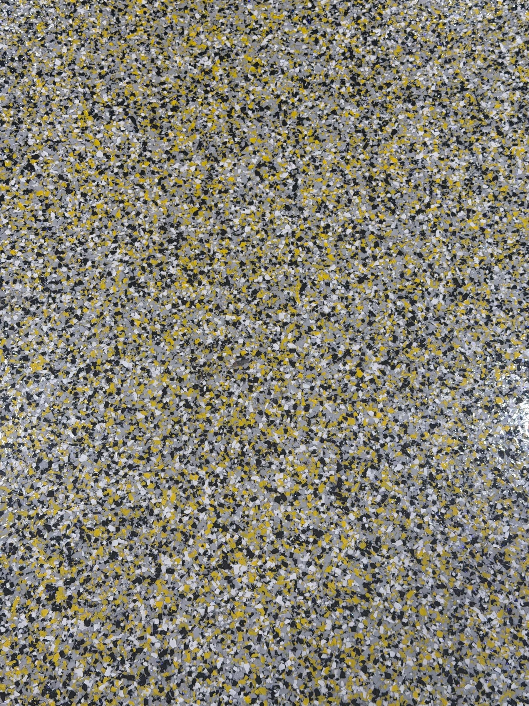 Grey and yellow flake floor coating close-up by Colin Coatings, Des Moines, Iowa