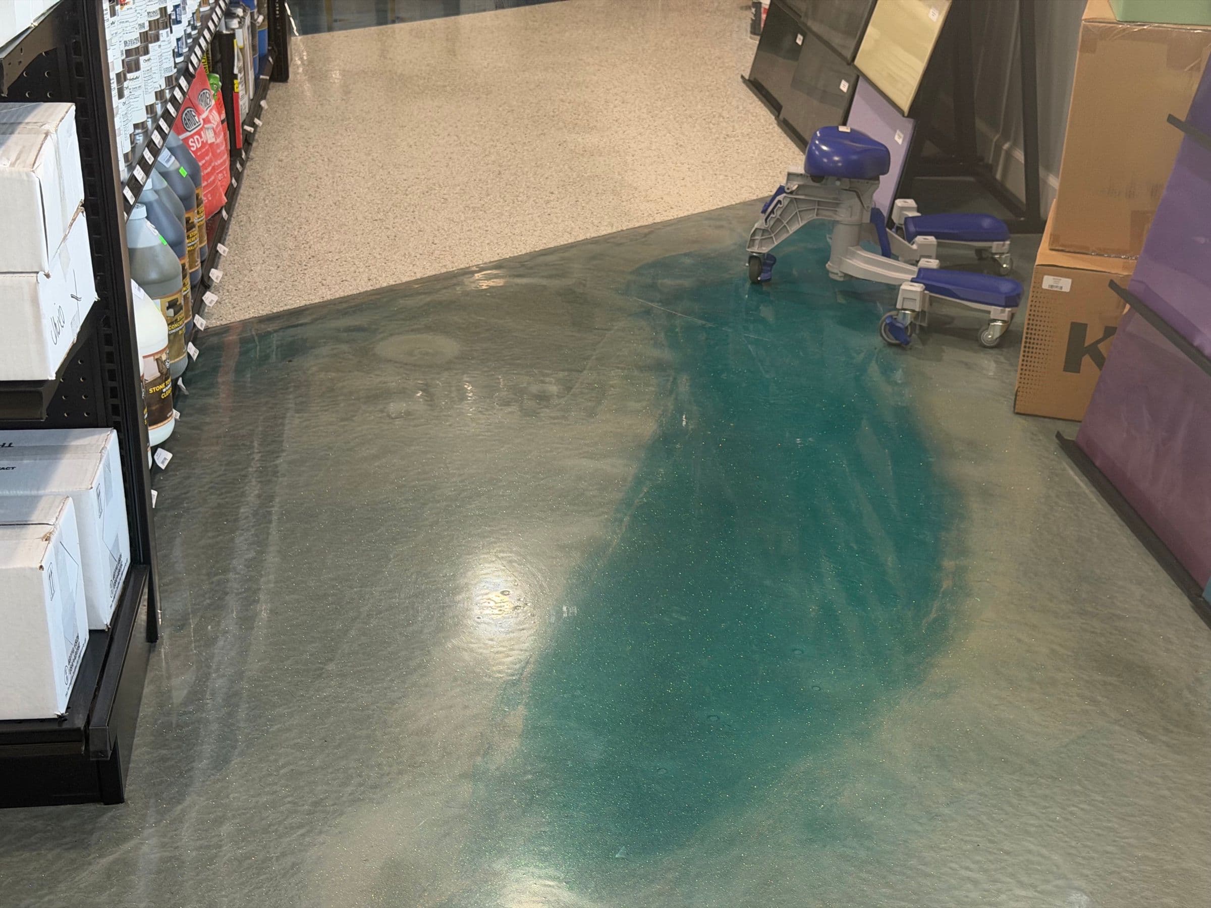 Teal metallic epoxy floor in a retail space by Colin Coatings, Des Moines, Iowa