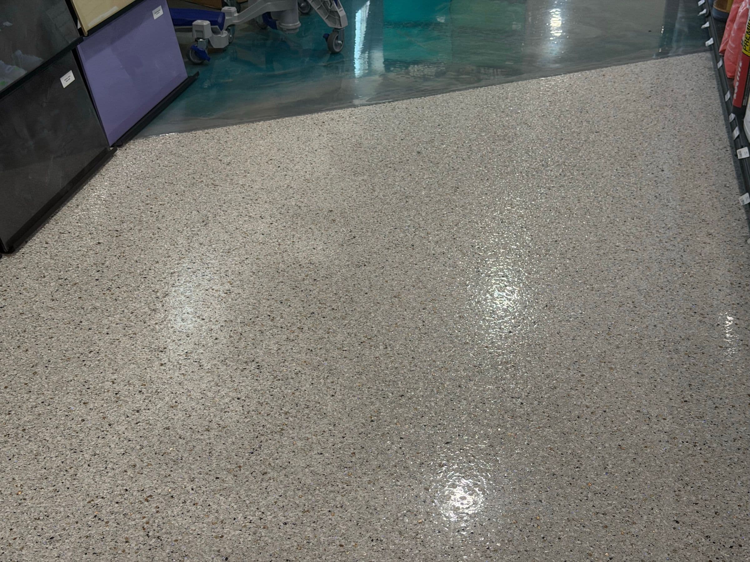 Glossy light grey flake floor in a finished commercial space by Colin Coatings, Des Moines, Iowa