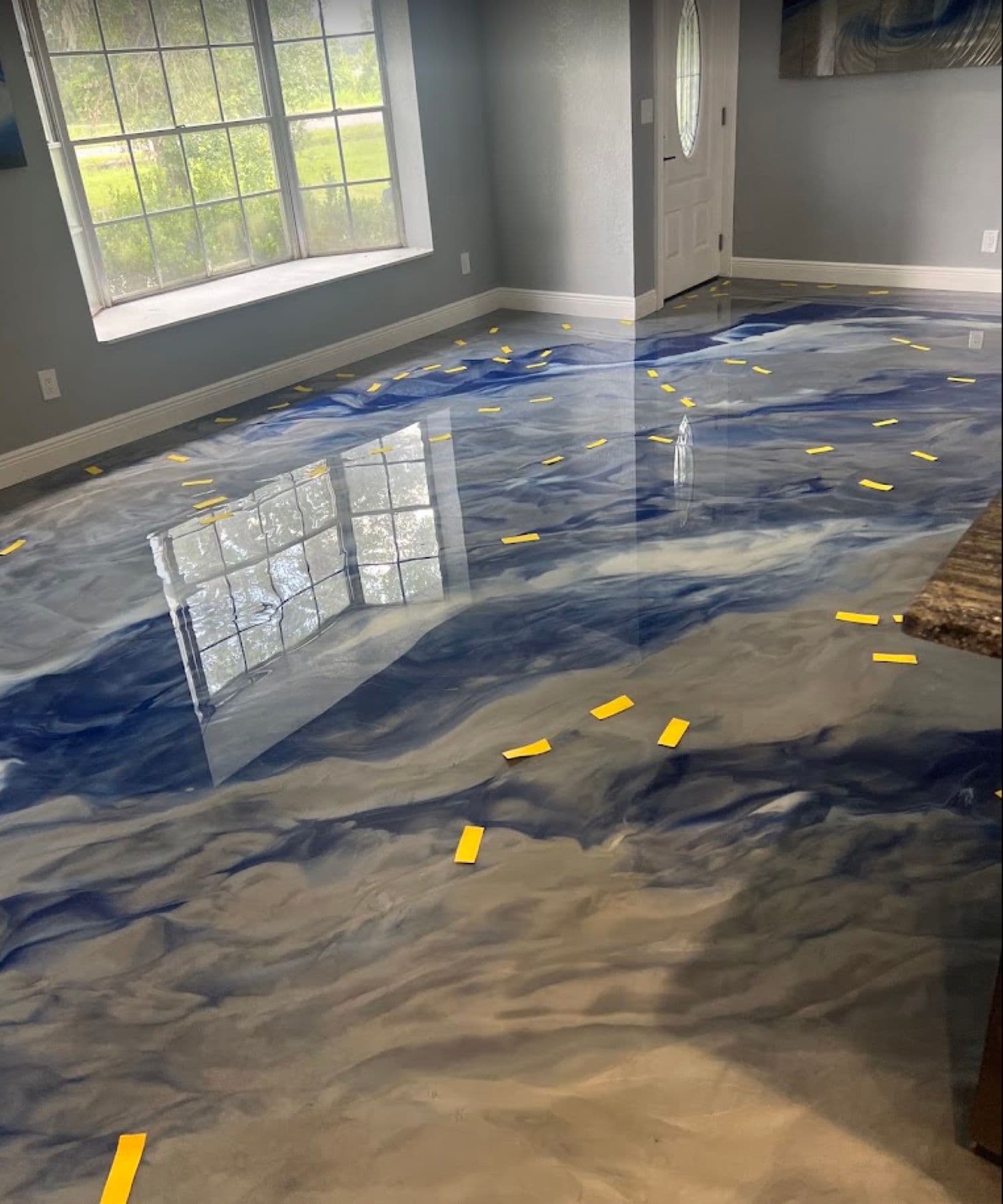 Blue and white metallic epoxy floor in a Des Moines home